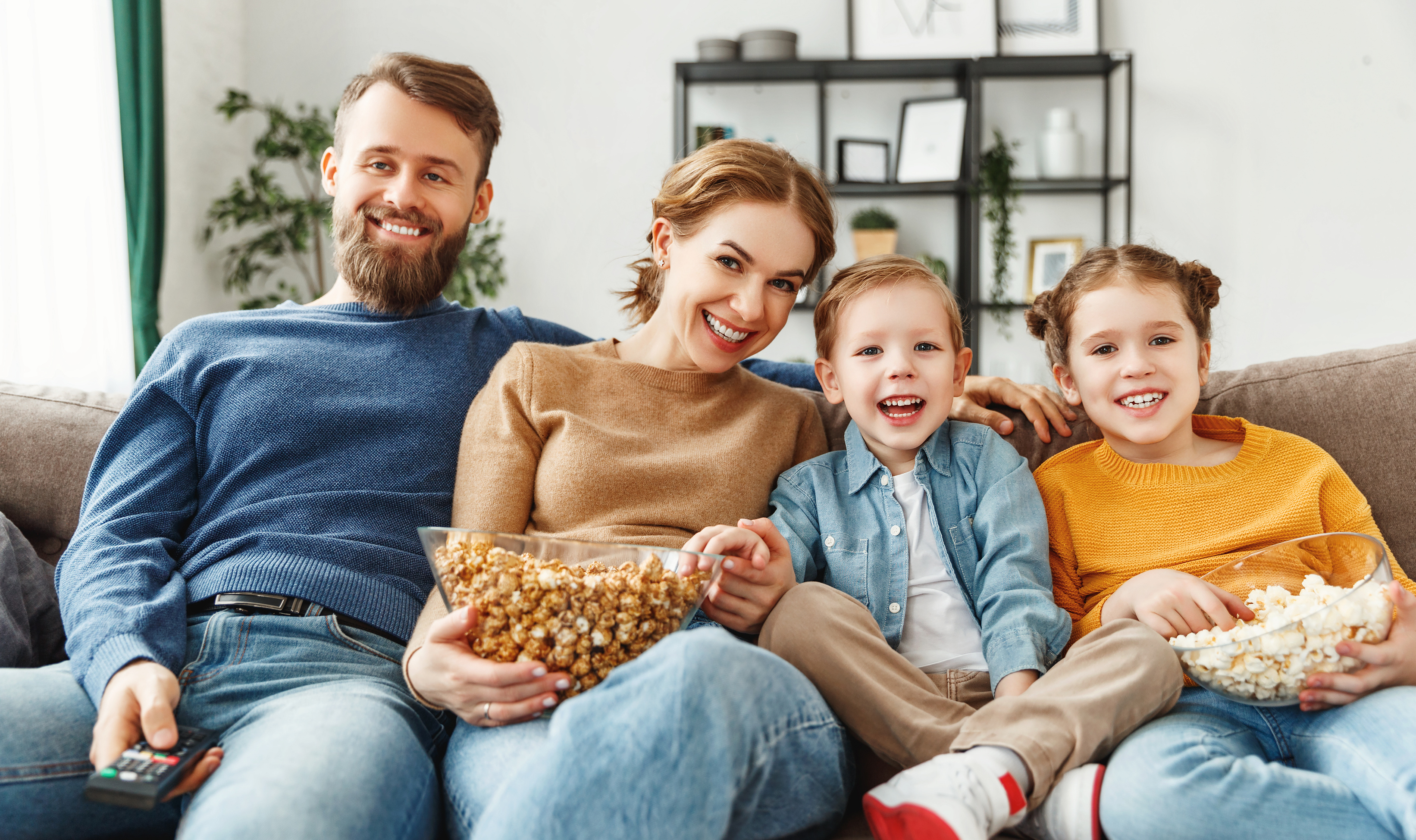 Laughing family watching movie together